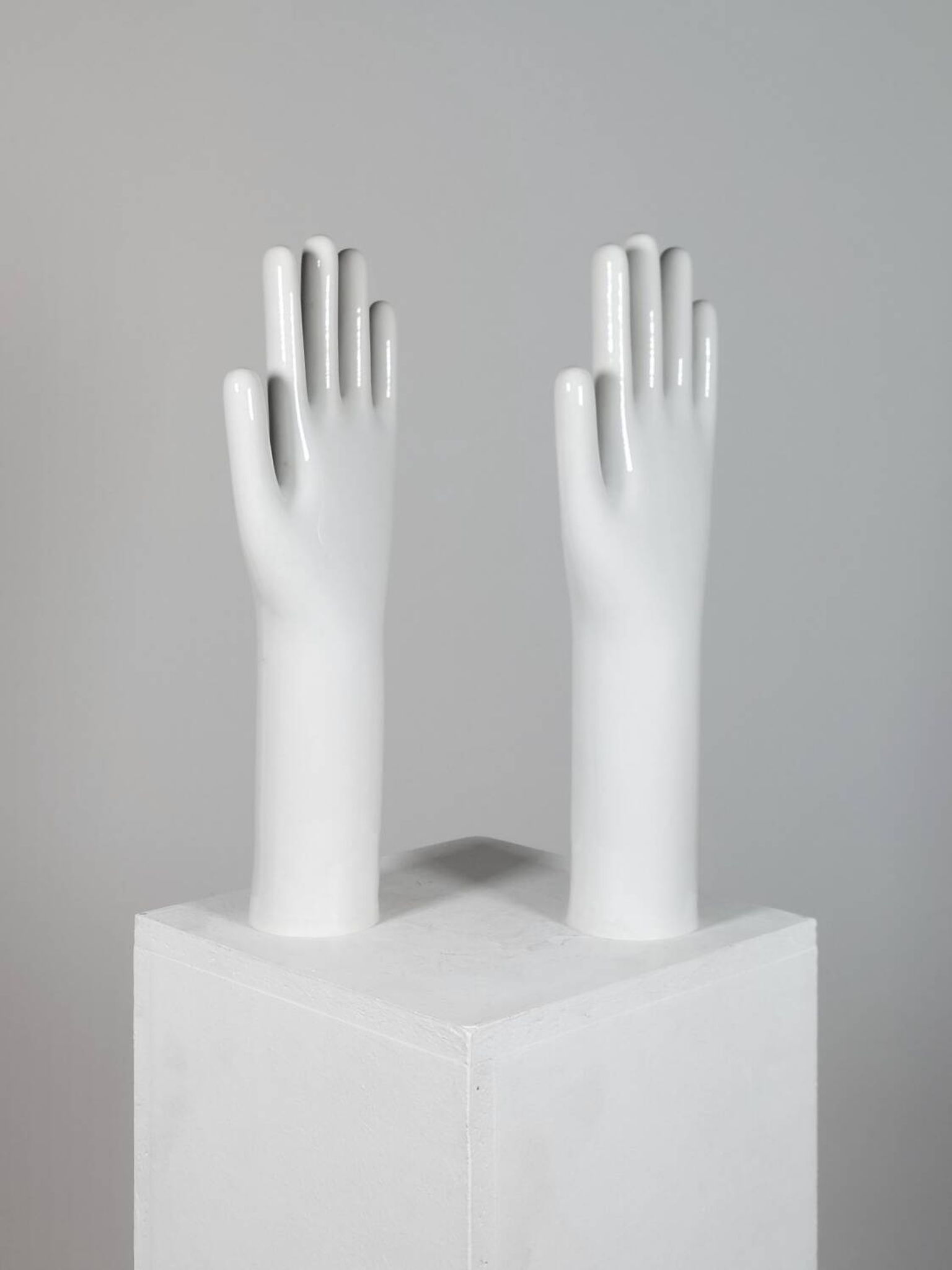 Pair of authentic vintage jewellery displays in industrial porcelain representing hands.