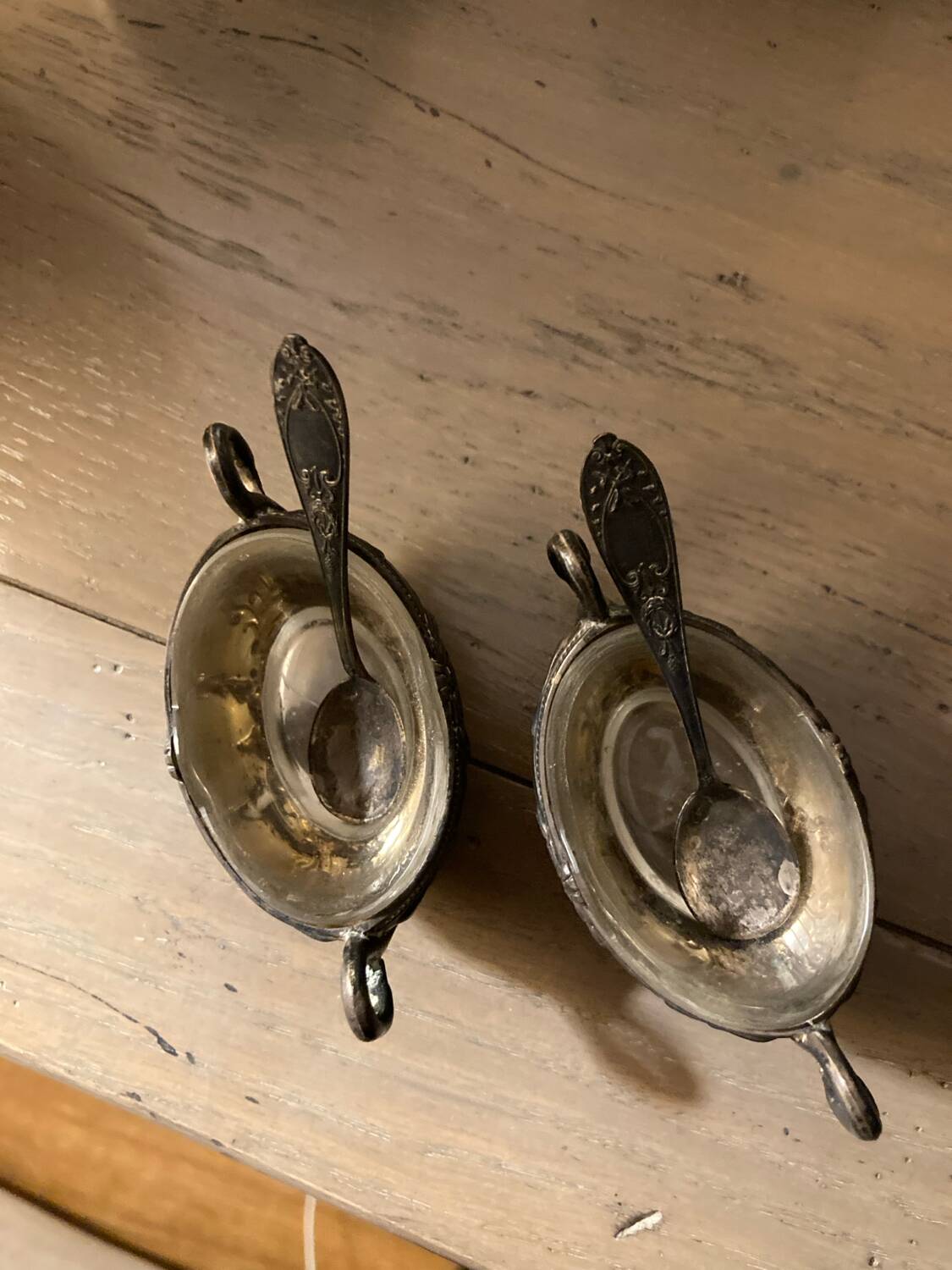 Salt and pepper shakers with silver spoons