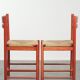 Set of two red vintage wooden chairs from the 1970s with woven rattan seats
