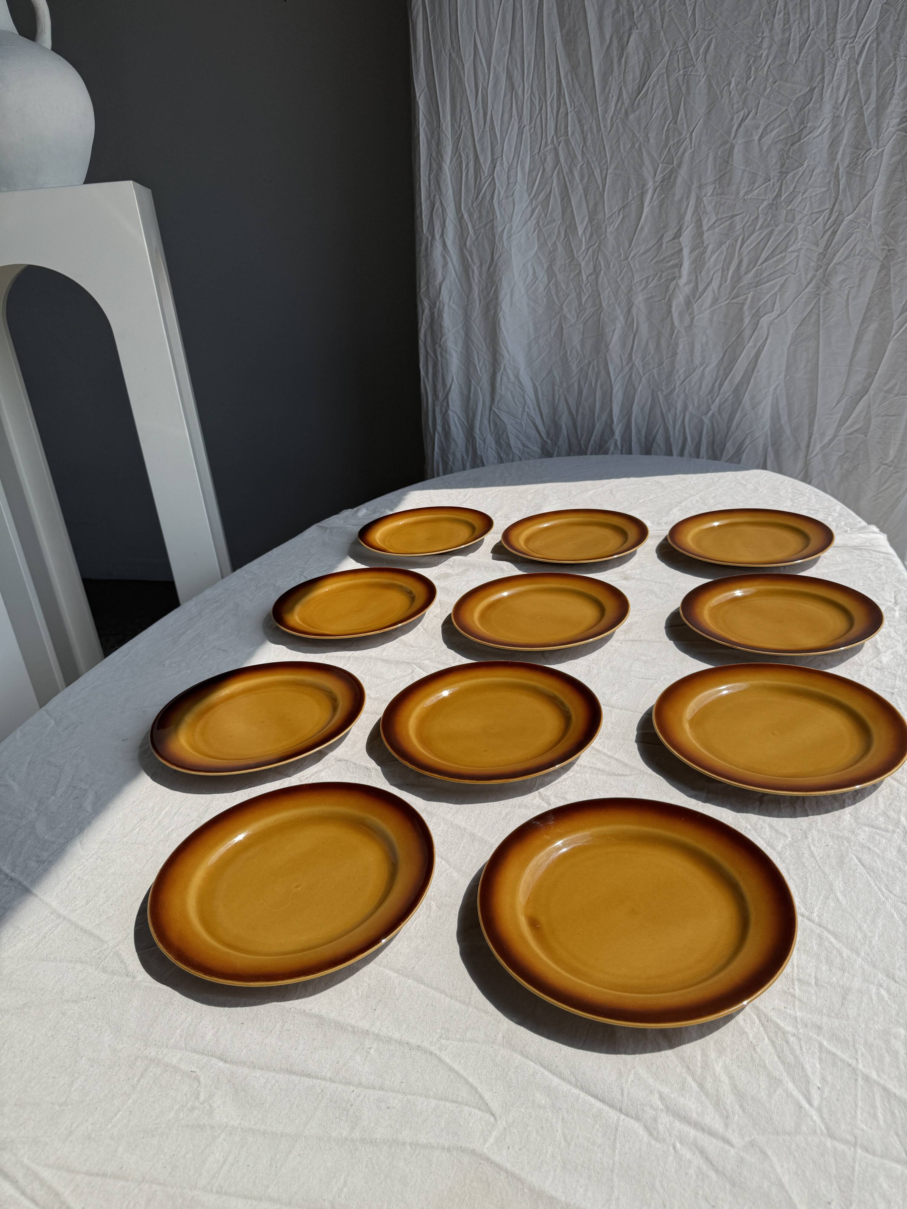 Set of 11 dark brown yellow stoneware plates D24