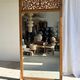 Very large freestanding teak mirror with an openwork carved pediment, Indonesia.