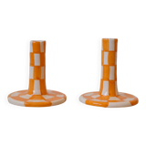 Pair of yellow and white checkered ceramic candlesticks