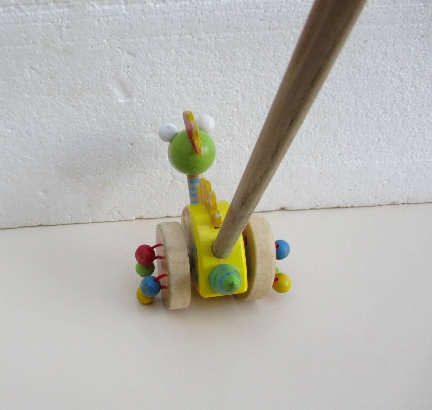 Push toy, wooden dinosaur. Brand: Bino
