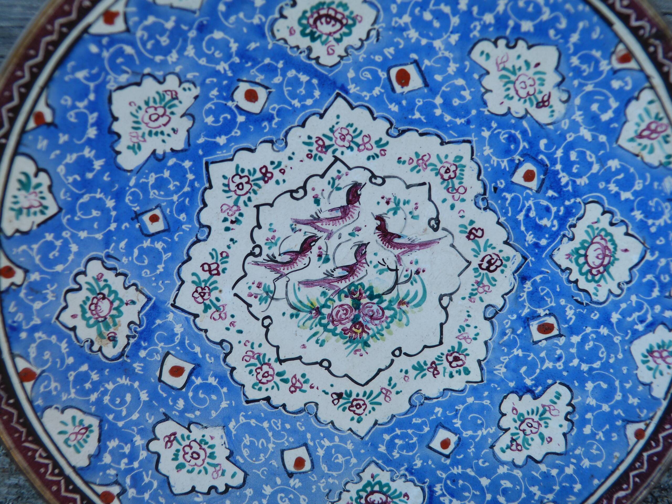 Decorative plate in blue enameled metal with bird motifs