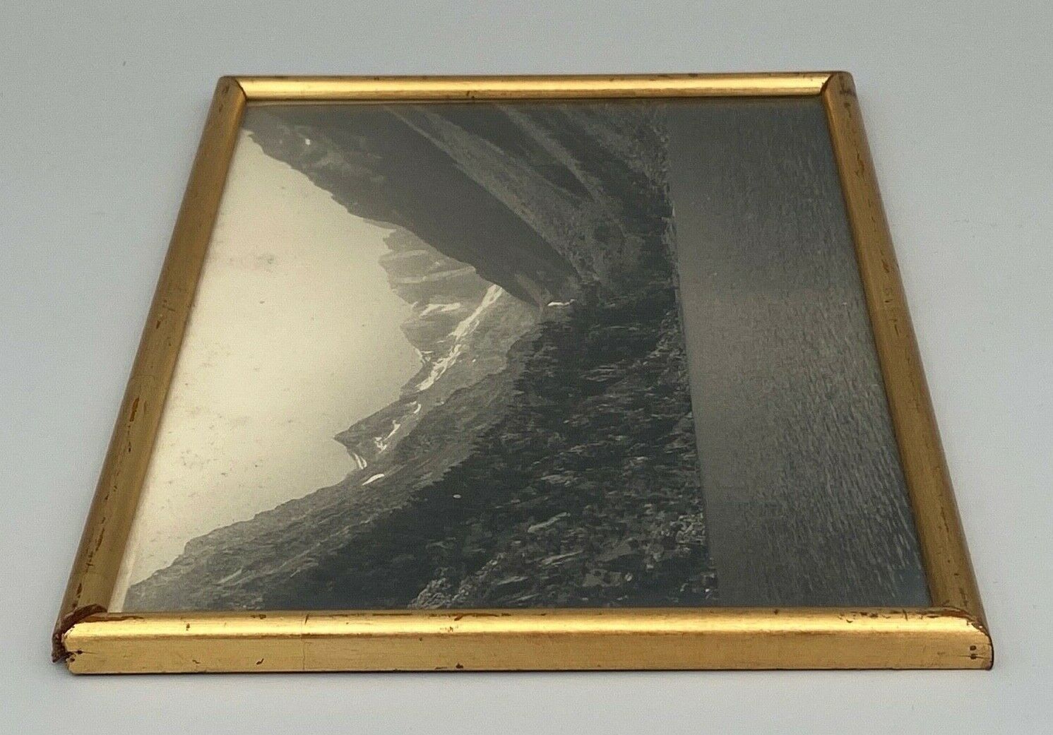 Photo in black and white mountain lake in golden frame