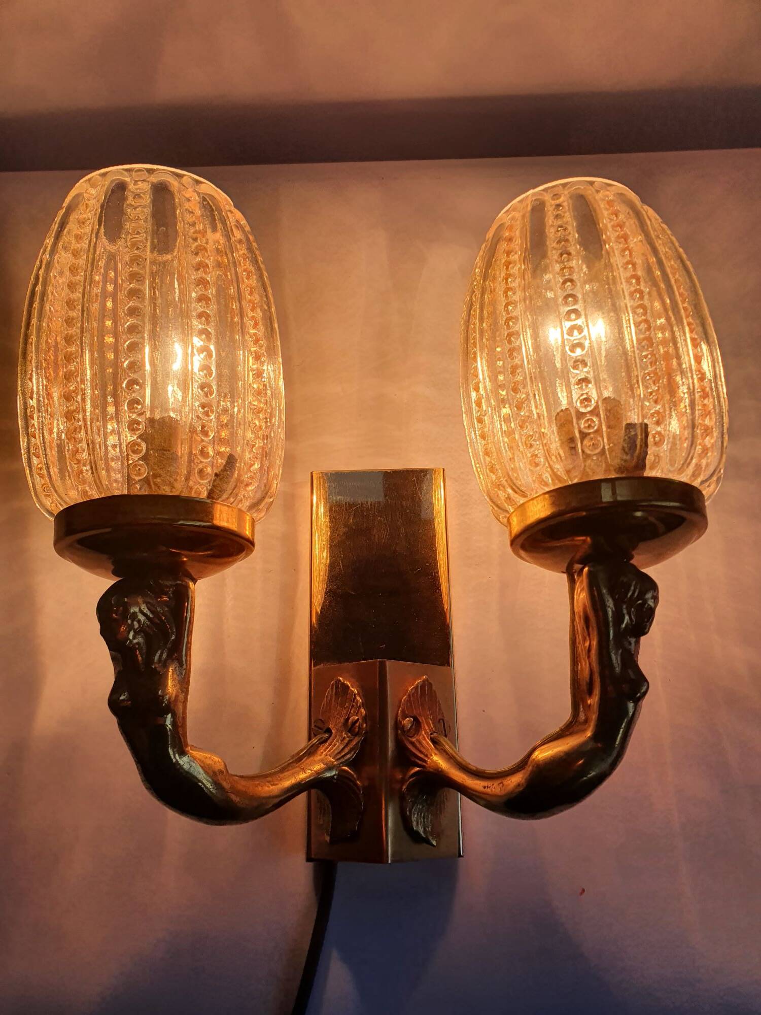 Golden bronze wall lamp with mermaids for an old bathroom.
