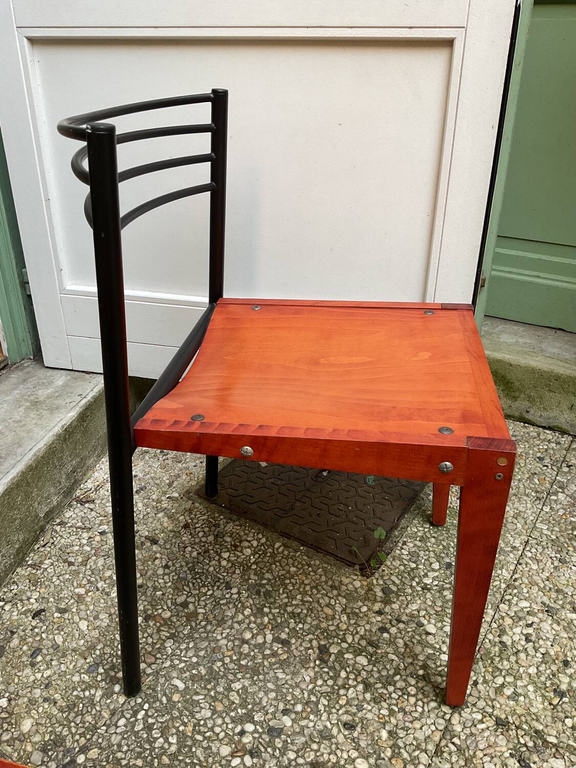 Chair with wooden seat and rare steel back