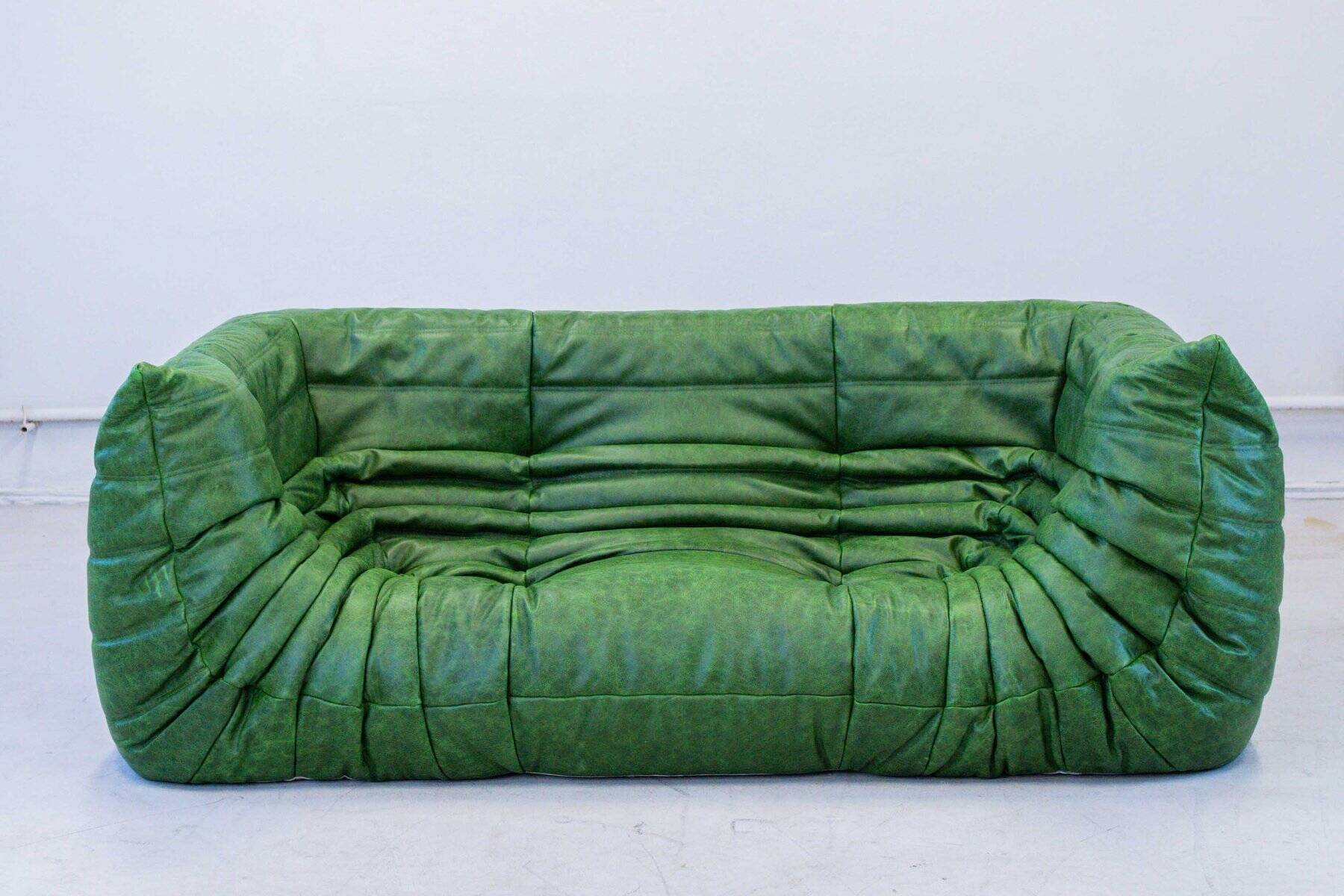 Vintage two-seat Togo sofa with arms in green leather by Michel Ducaroy for Ligne Roset, 1970s