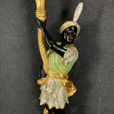 Early XXth era polychrome wooden torch has figuration of a Moor in traditional costume from the 18th