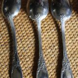 A set of 6 silver-plated metal soup spoons with foliage design.