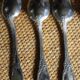A set of 6 silver-plated metal soup spoons with foliage design.