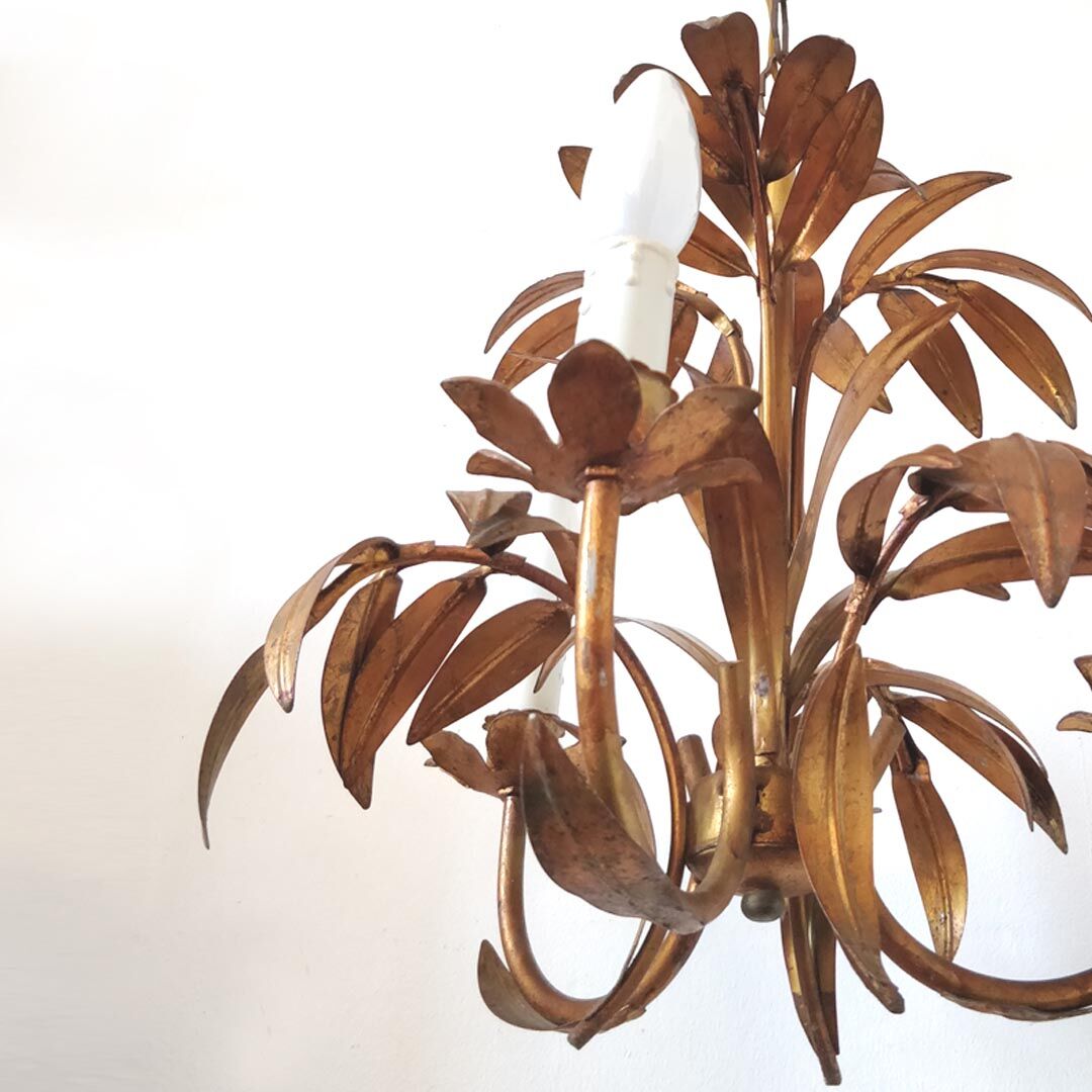 Golden metal chandelier palm leaves