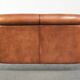 Sheepskin 2-seater sofa with a warm cognac brown colour scheme