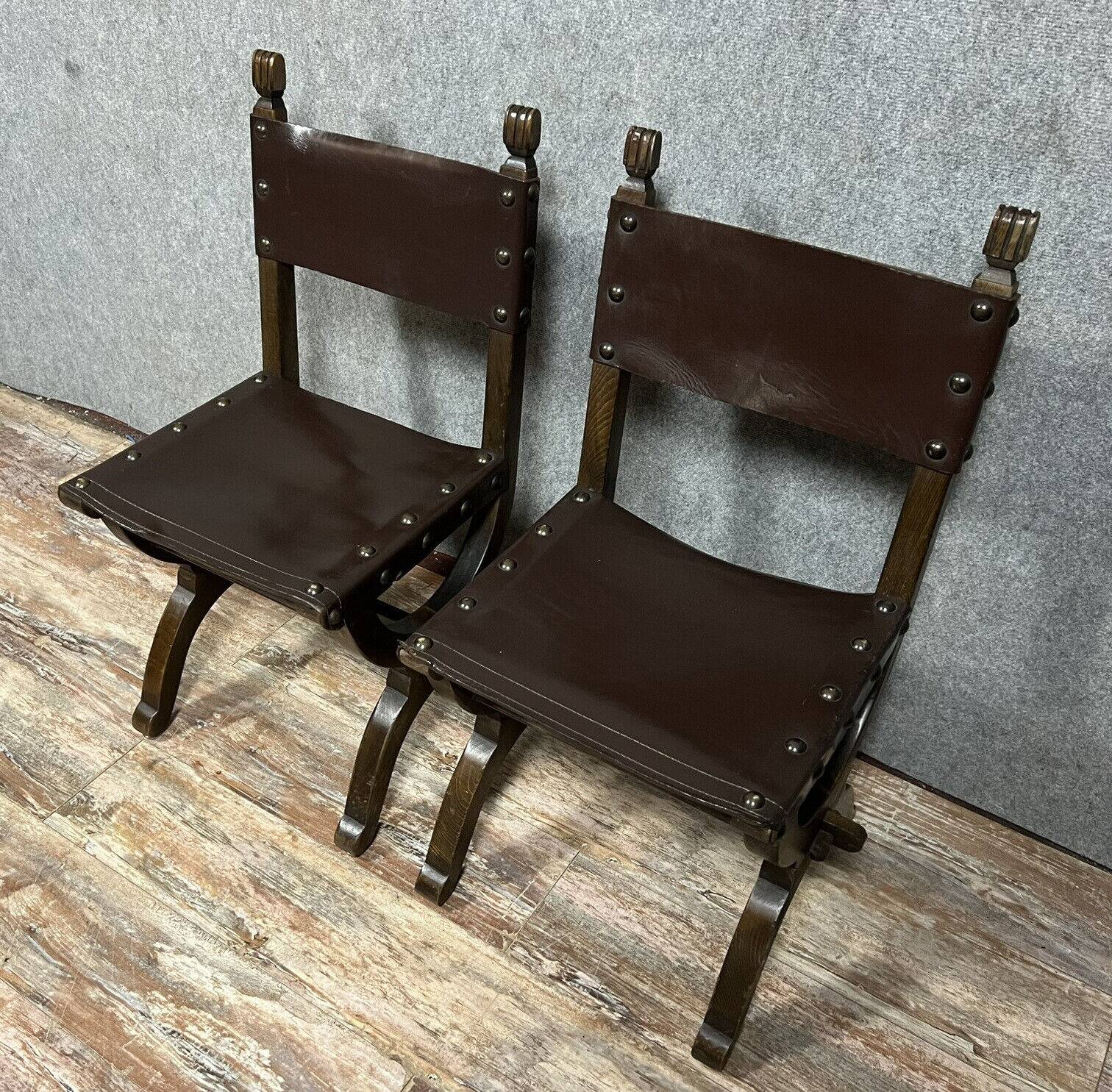 Pair of medieval style chairs in solid wood and leather, 19th century, circa 1850