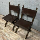 Pair of medieval style chairs in solid wood and leather, 19th century, circa 1850