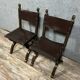 Pair of medieval style chairs in solid wood and leather, 19th century, circa 1850