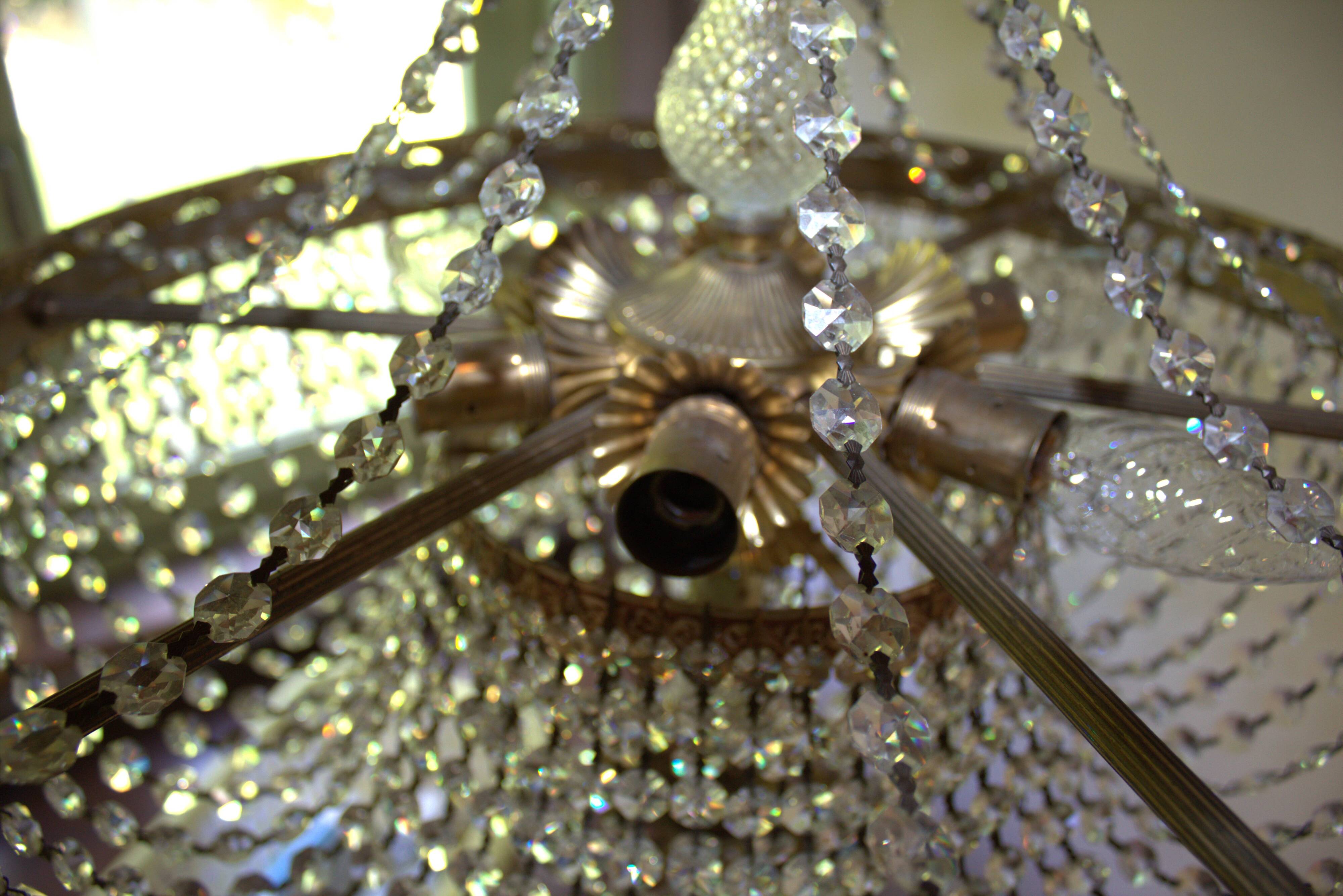 Antique castle style chandelier with tassels and floral details