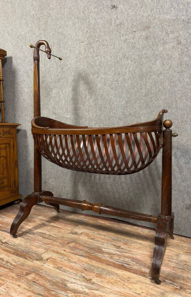 Empire style mahogany cradle with a swan neck, shaped like a cradle, circa 1810