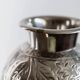 Vintage Italian vase in nickel-plated brass from the 1960s, hand-hammered relief of fruits and leaves.