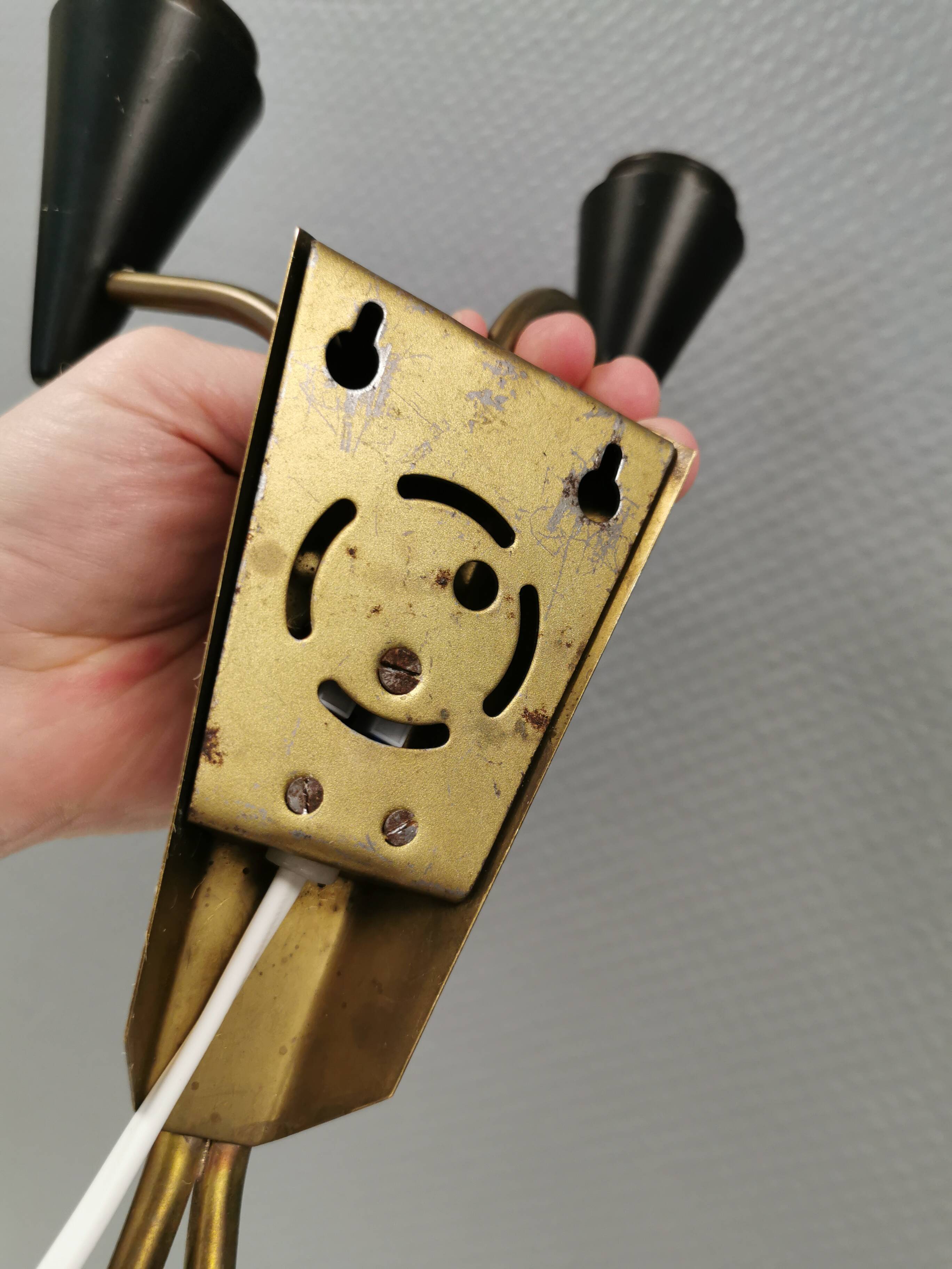 A set of wall lamps in black lacquered metal with brass details