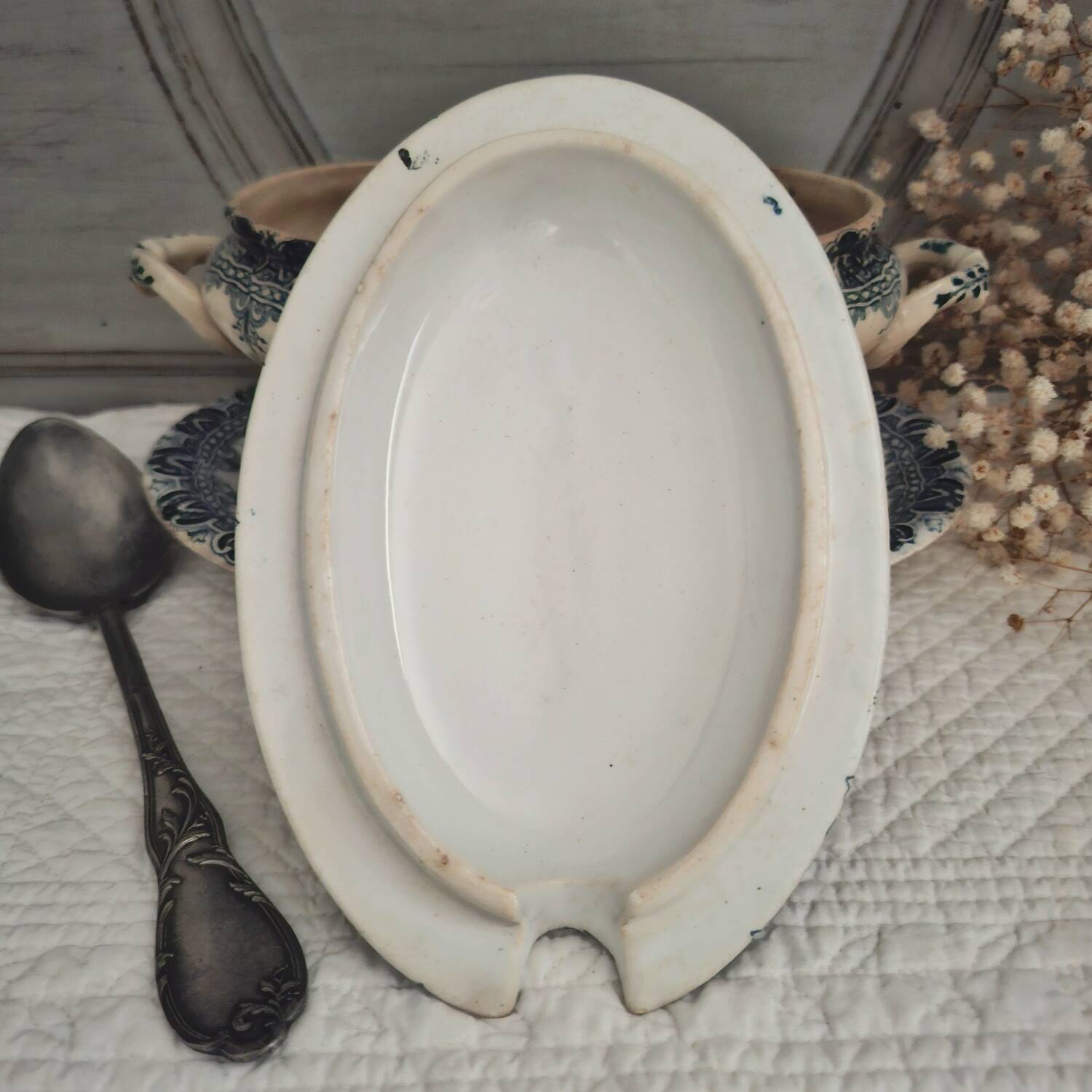 Antique iron earthenware sauceboat on a frame