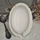 Antique iron earthenware sauceboat on a frame