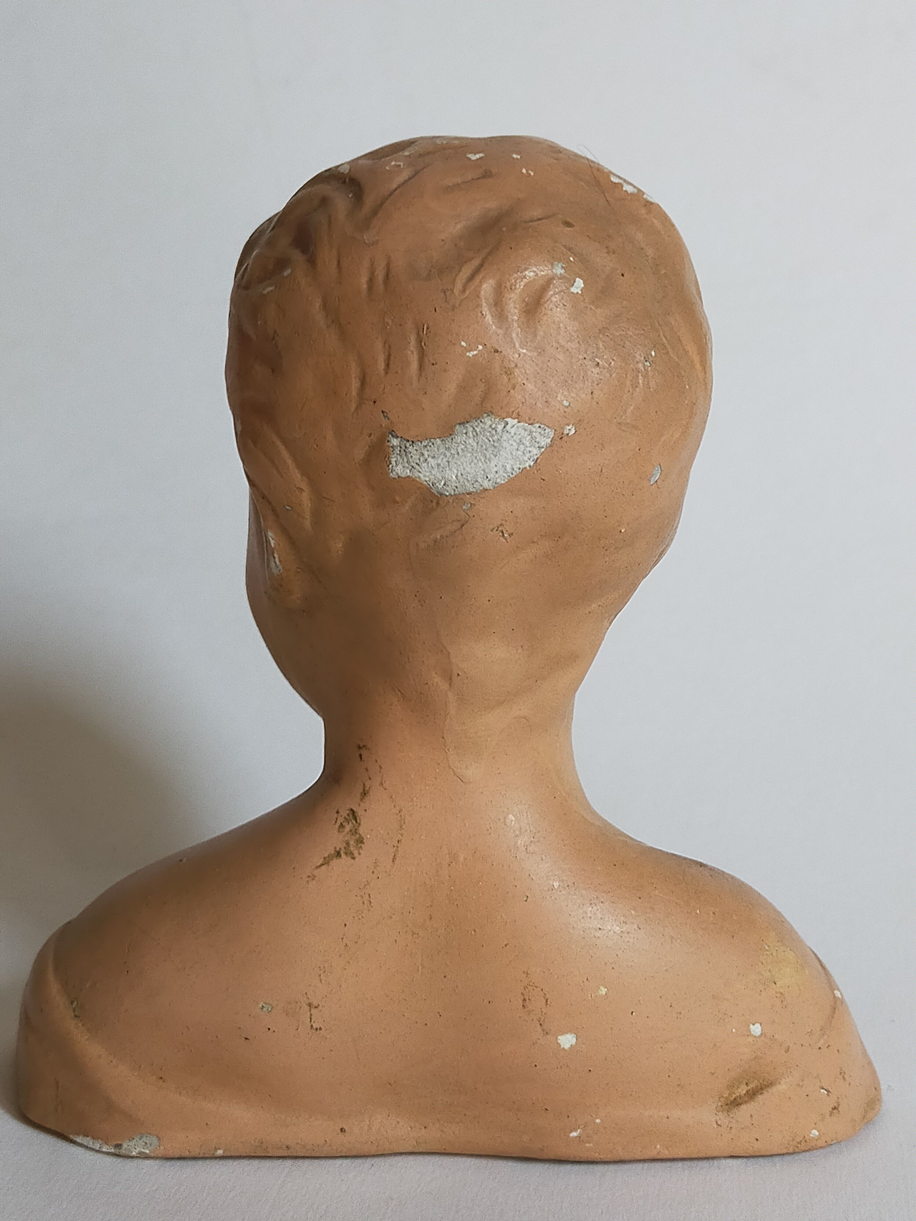 Bust of a small child in ancient plaster