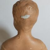 Bust of a small child in ancient plaster