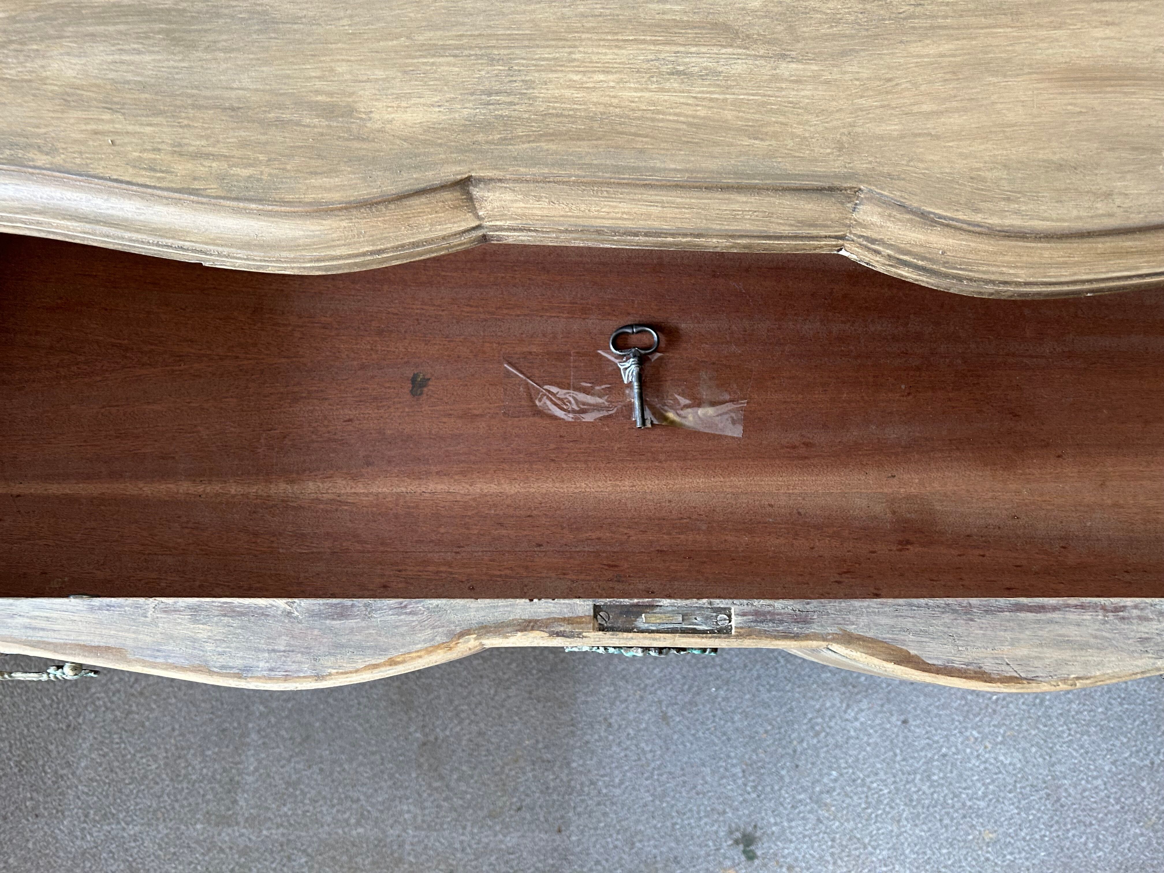 Patinated baroque crossbow chest of drawers