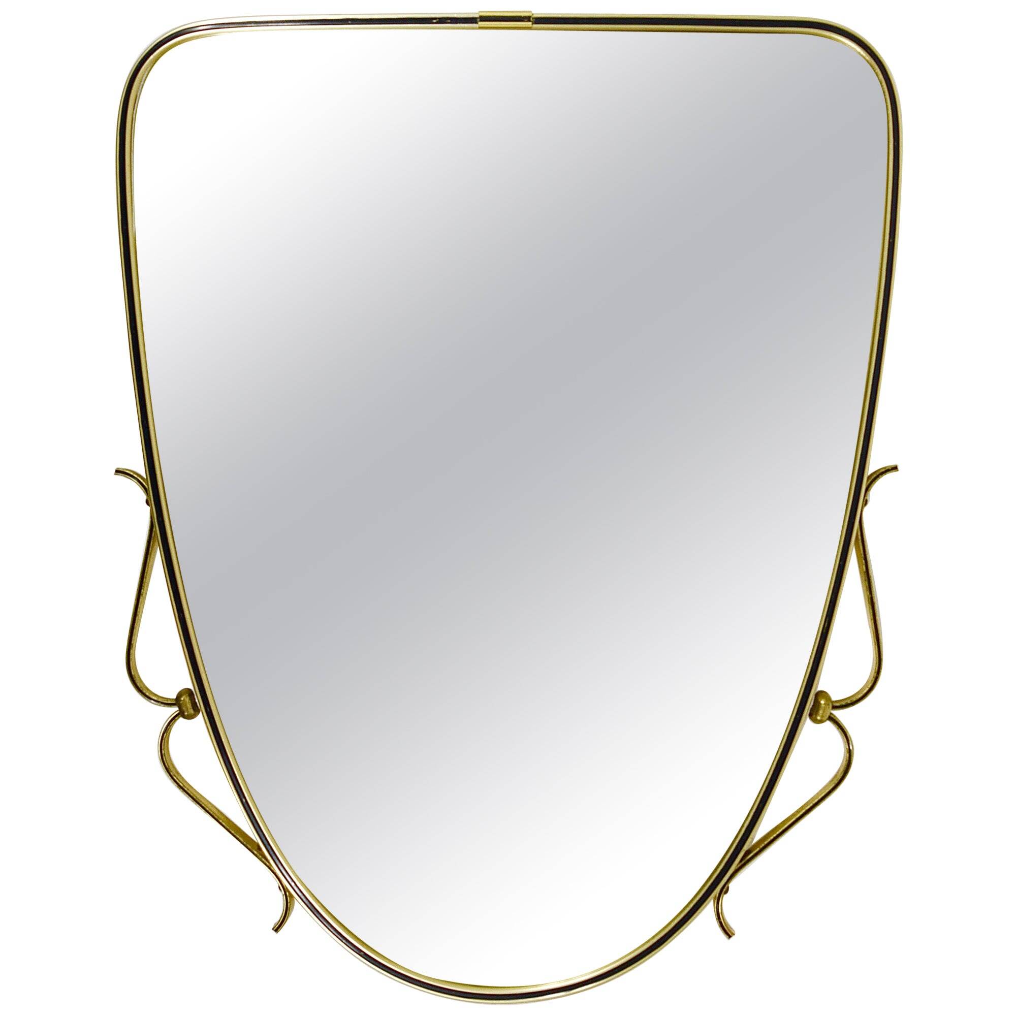 Elegant wall mirror in brass and black from the mid-century, Italy, 1950s.