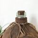Big demijohn with burlap
