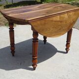 Round drop-leaf table made entirely of solid walnut