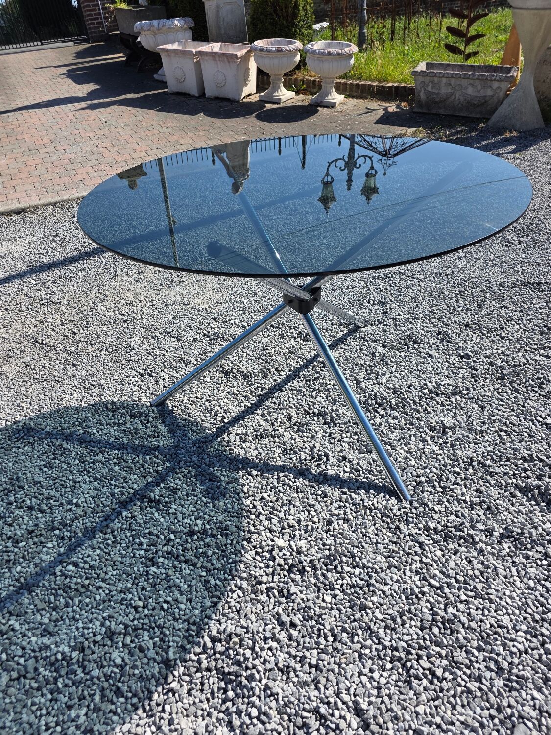 Round chrome metal table with smoked glass top from the 70s