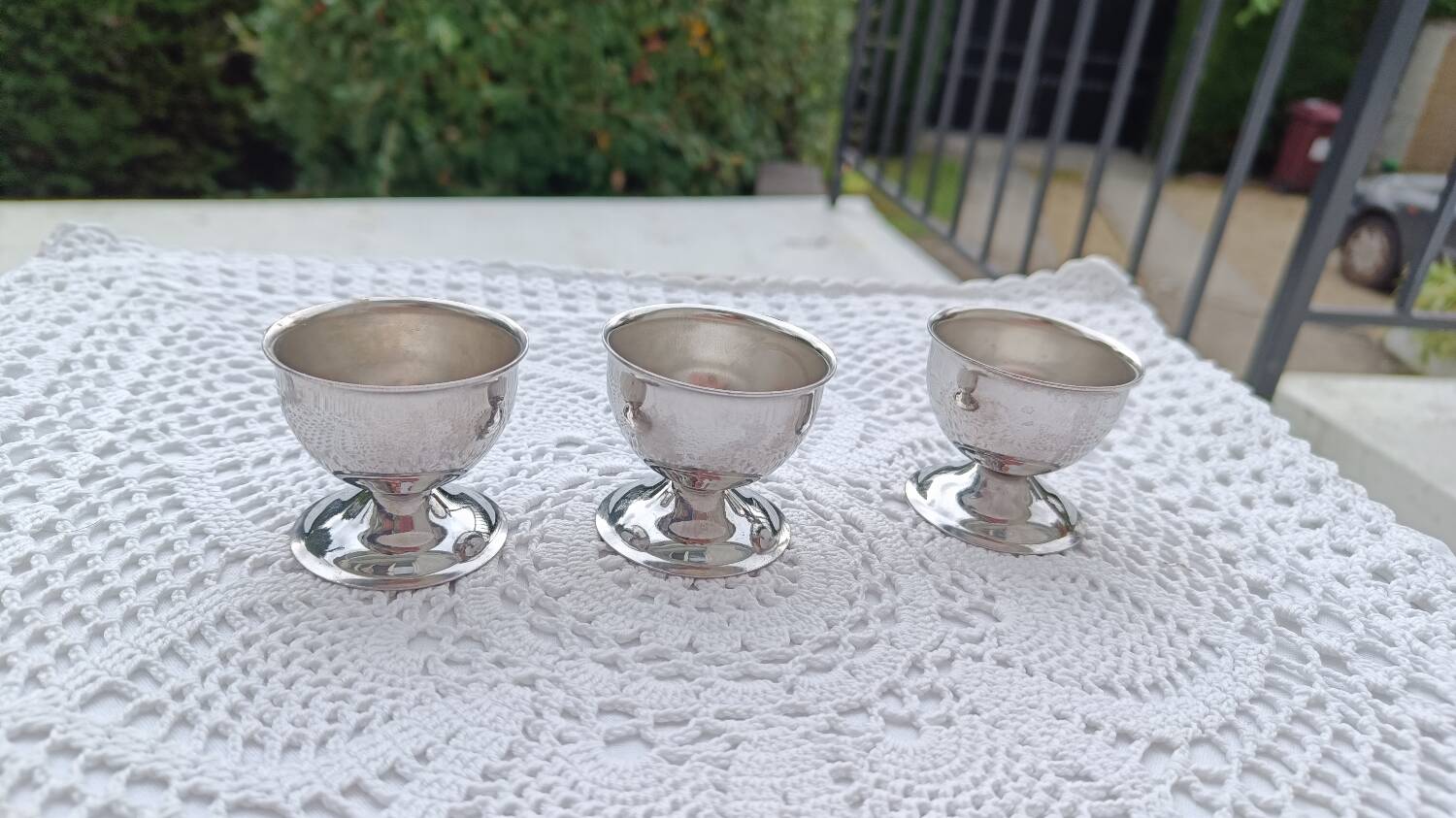 A set of 3 egg cups by Guy Degrenne.