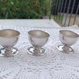 A set of 3 egg cups by Guy Degrenne.