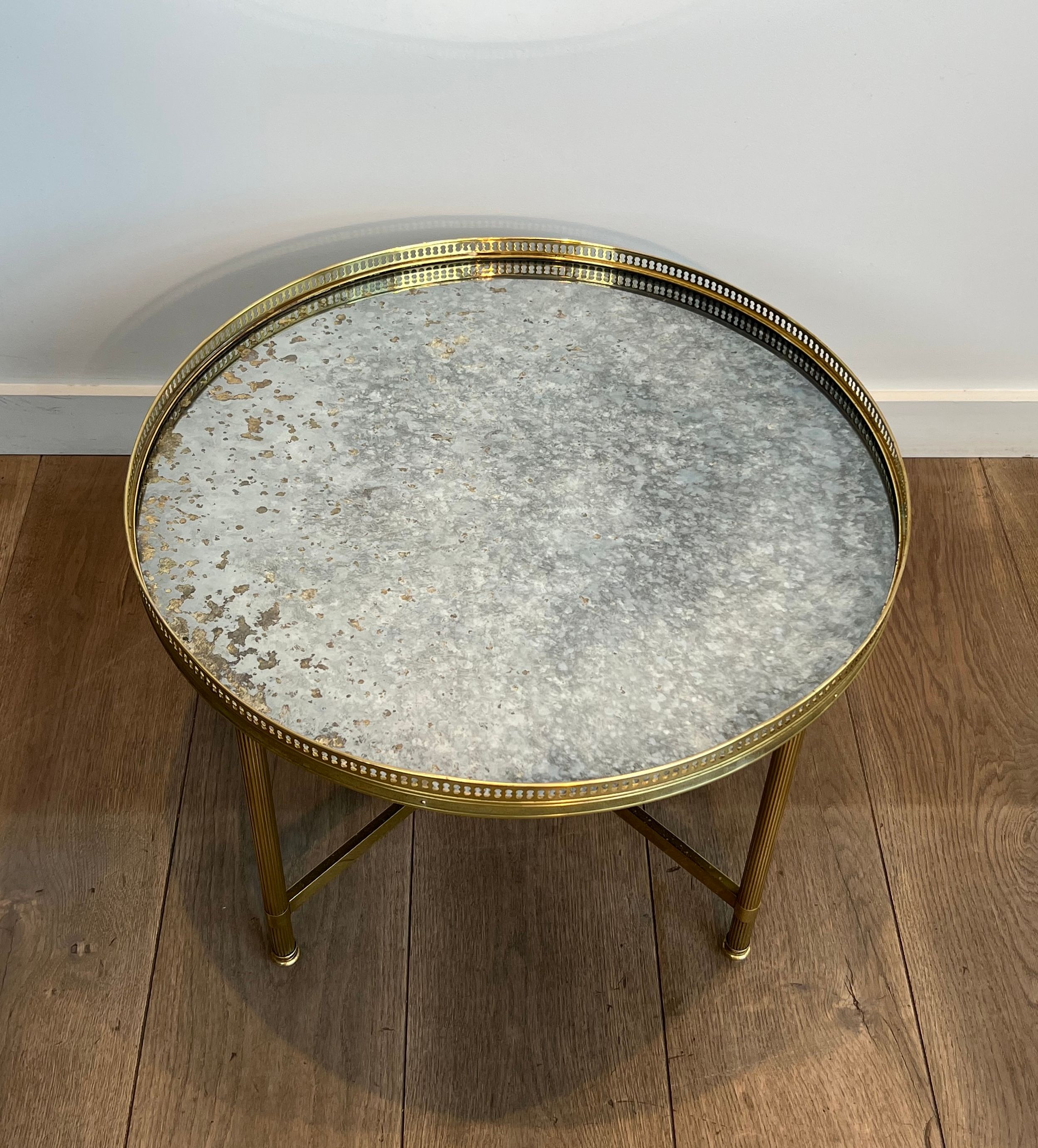 Brass coffee table with a vintage mirror top from the Baguès house.
