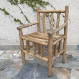 Art-Populaire armchair in raw wood, circa 1950.