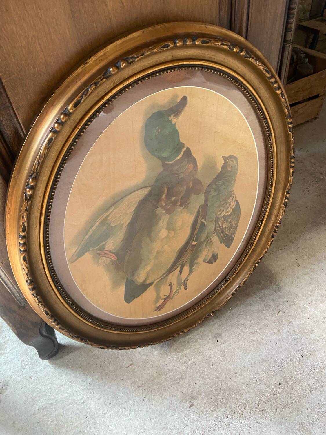 Antique oval frame with an oil painting of green collars