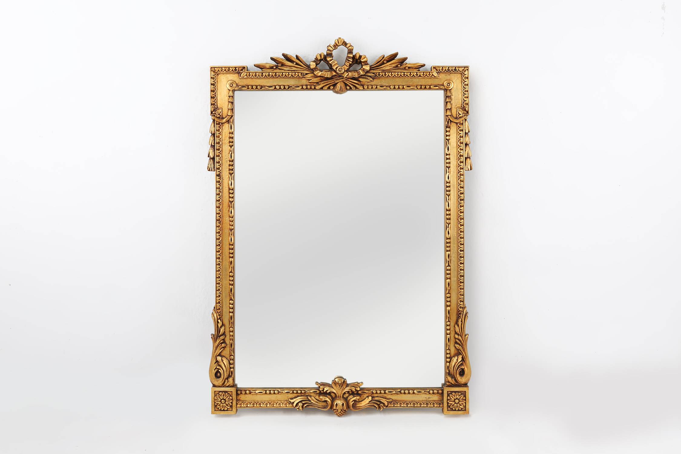 Highly decorated gilted carved wooden wall mirror, Belgium ca. 1950