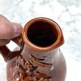 vintage ceramic pitcher with grape and vine decor