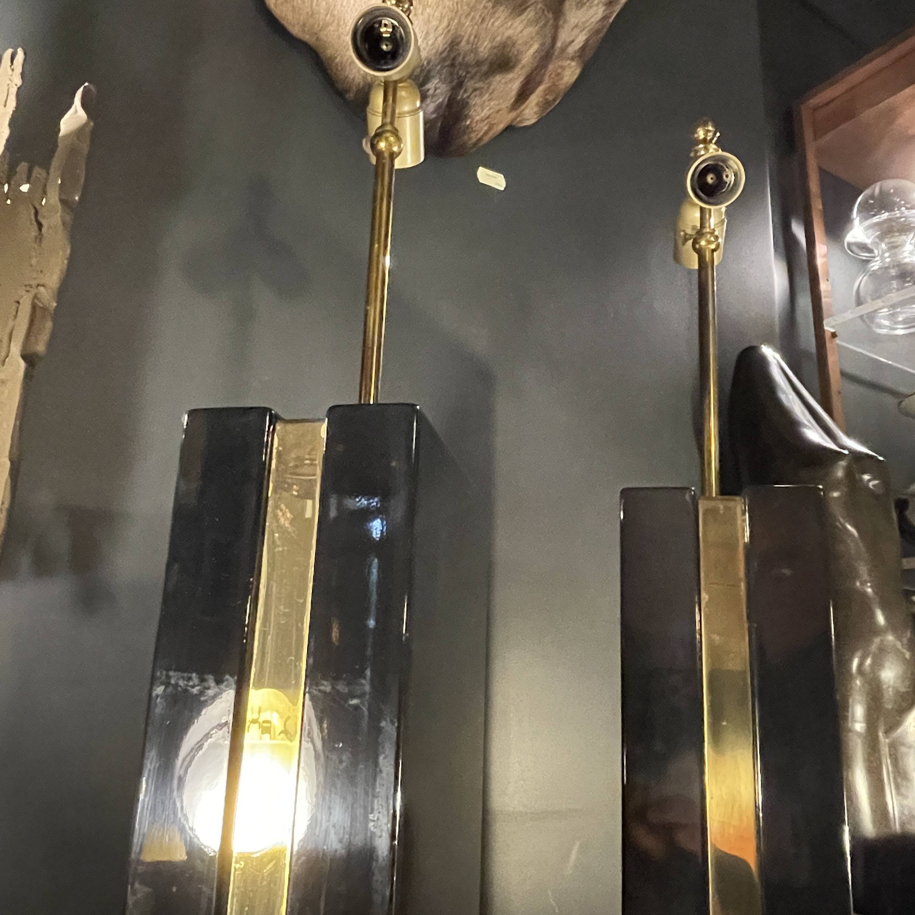 Pair of black lacquered and brass table lamps, circa 1970