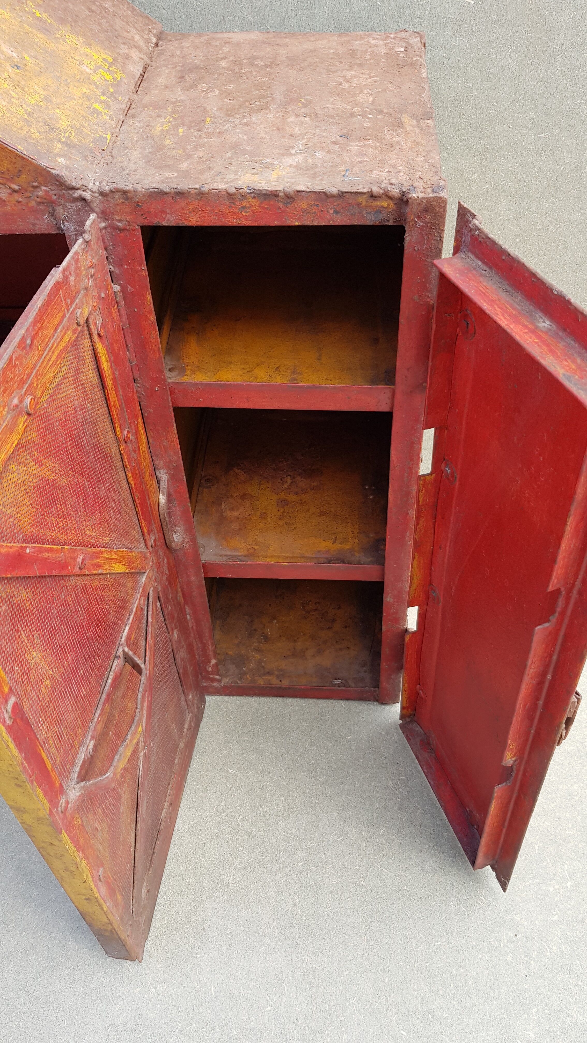 Old atypical metal workshop furniture with its original red patina