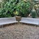 Pair of antique wooden slatted benches with wrought iron legs.