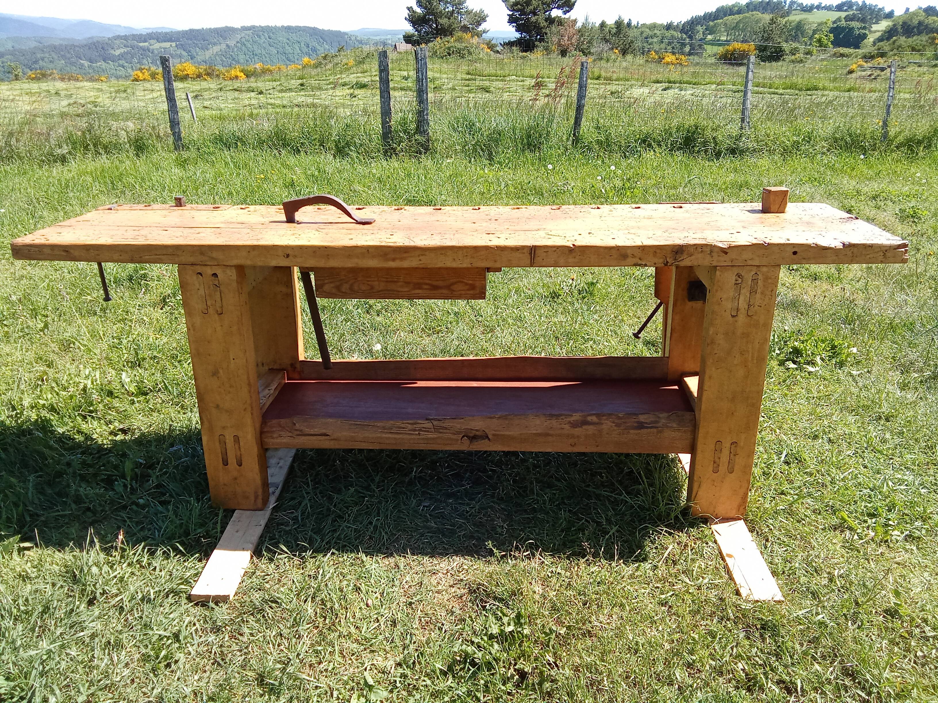 Old solid wood carpenter's bench with 2 functional vices.