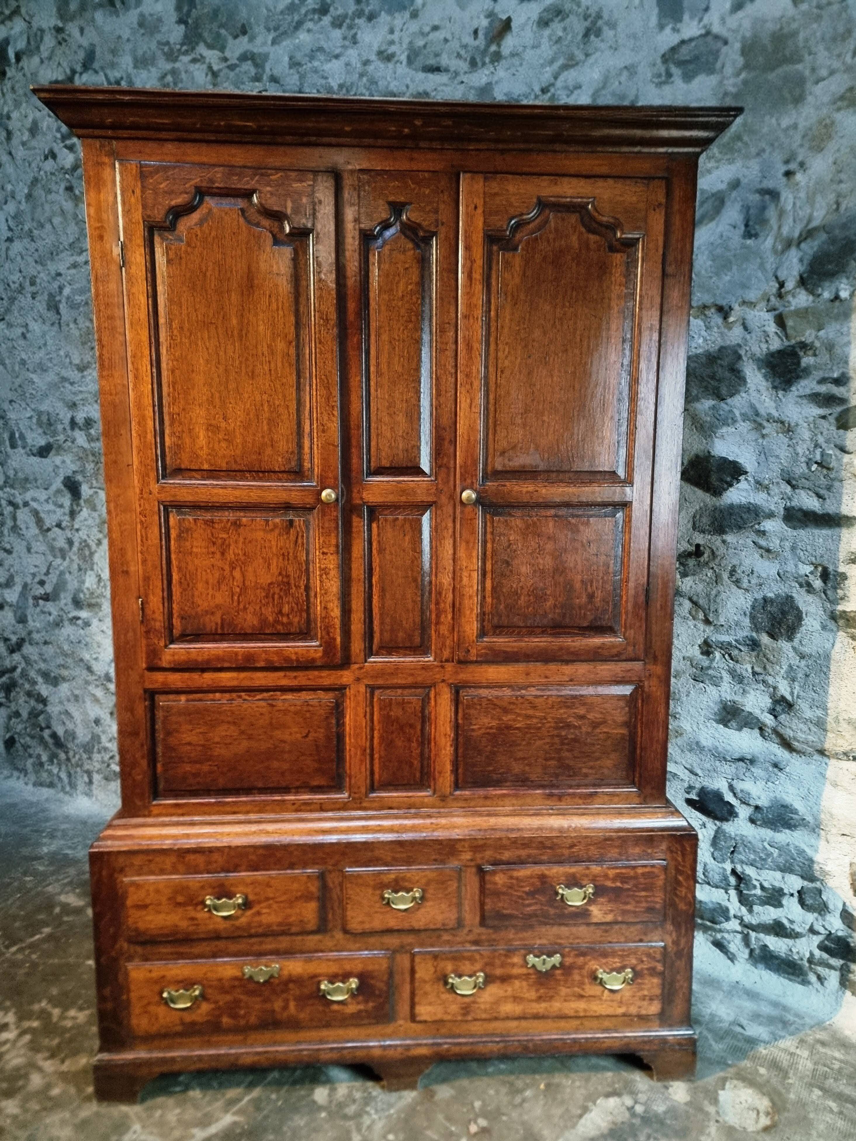 Antique English oak wardrobe with drawers, England, circa 1800–1820.