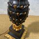 Large pineapple table lamp in carved black and gold wood, France, early 20th century.