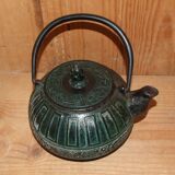 Japanese teapot in patinated green cast decorated with motifs