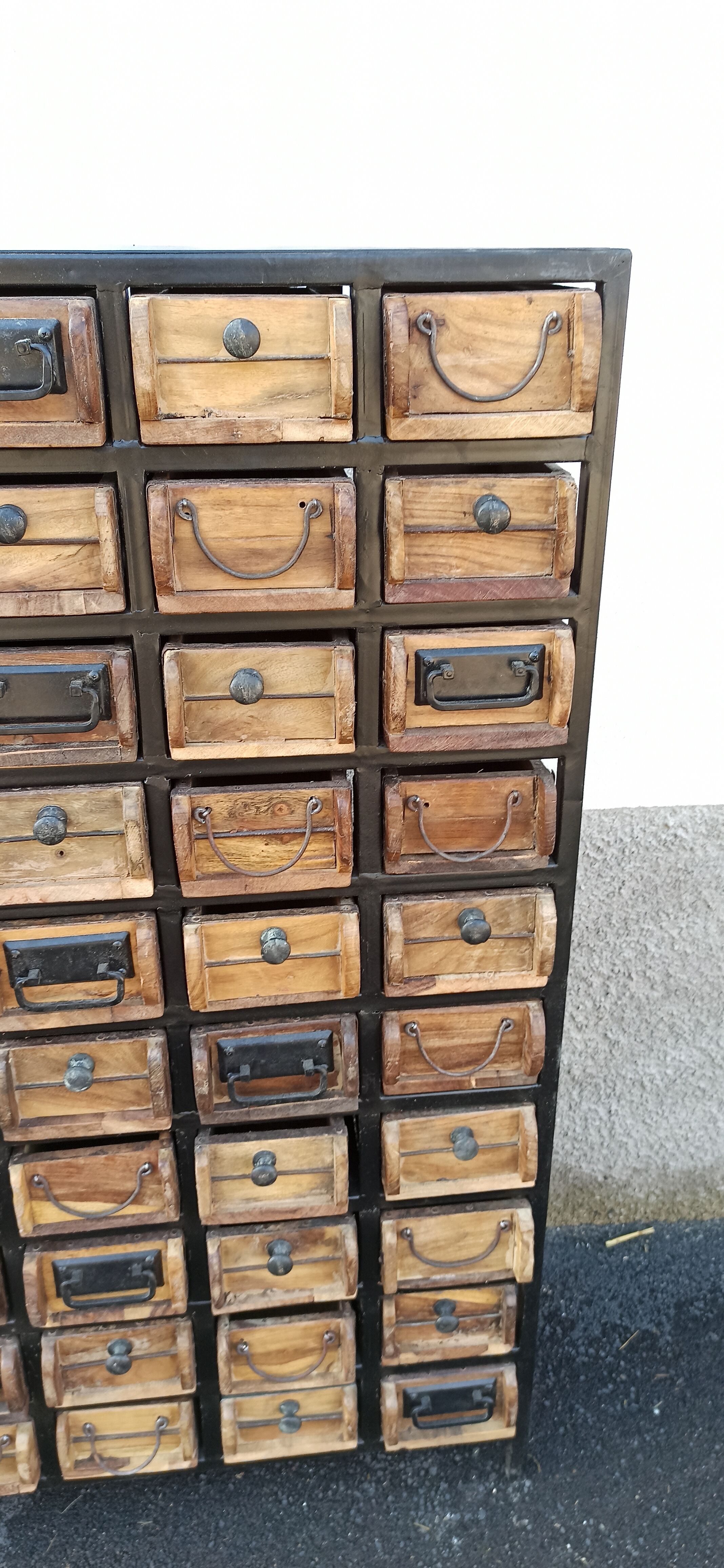 Black metal storage cabinet with 60 wooden drawers