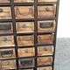 Black metal storage cabinet with 60 wooden drawers