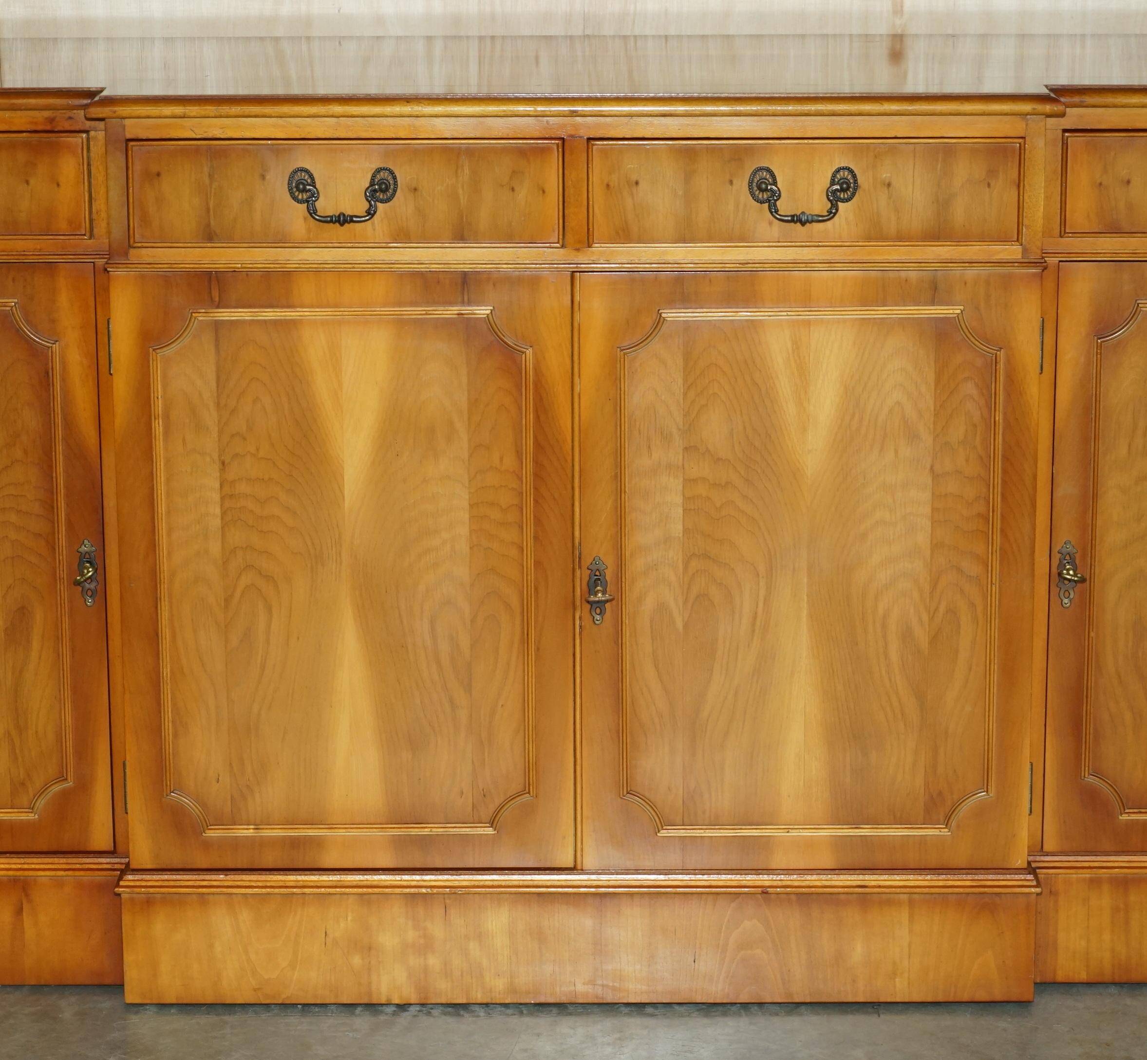 Vintage buffet made of mottled yew wood with three doors and four drawers.
